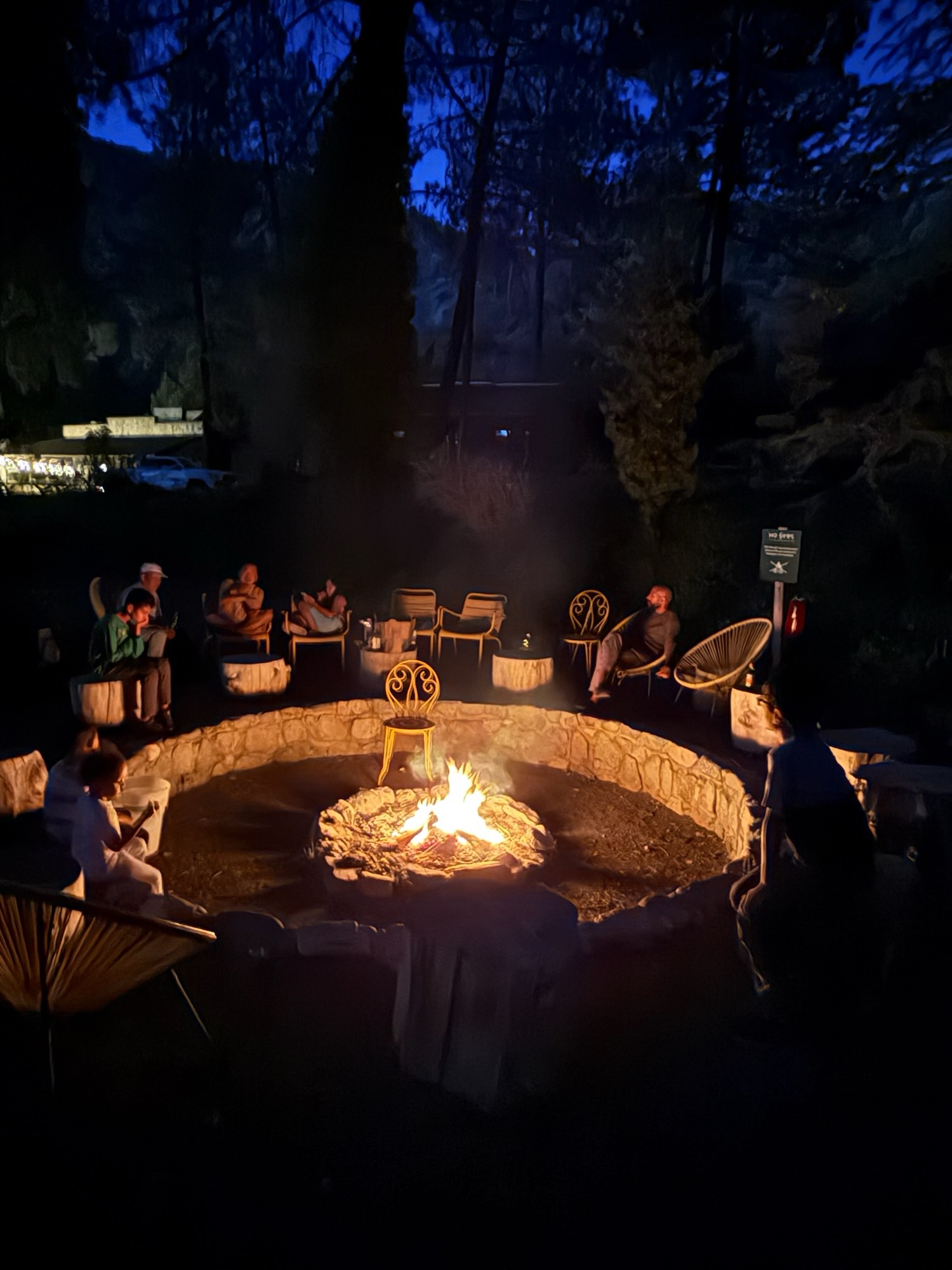 Family gathered at fire pit making s'mores