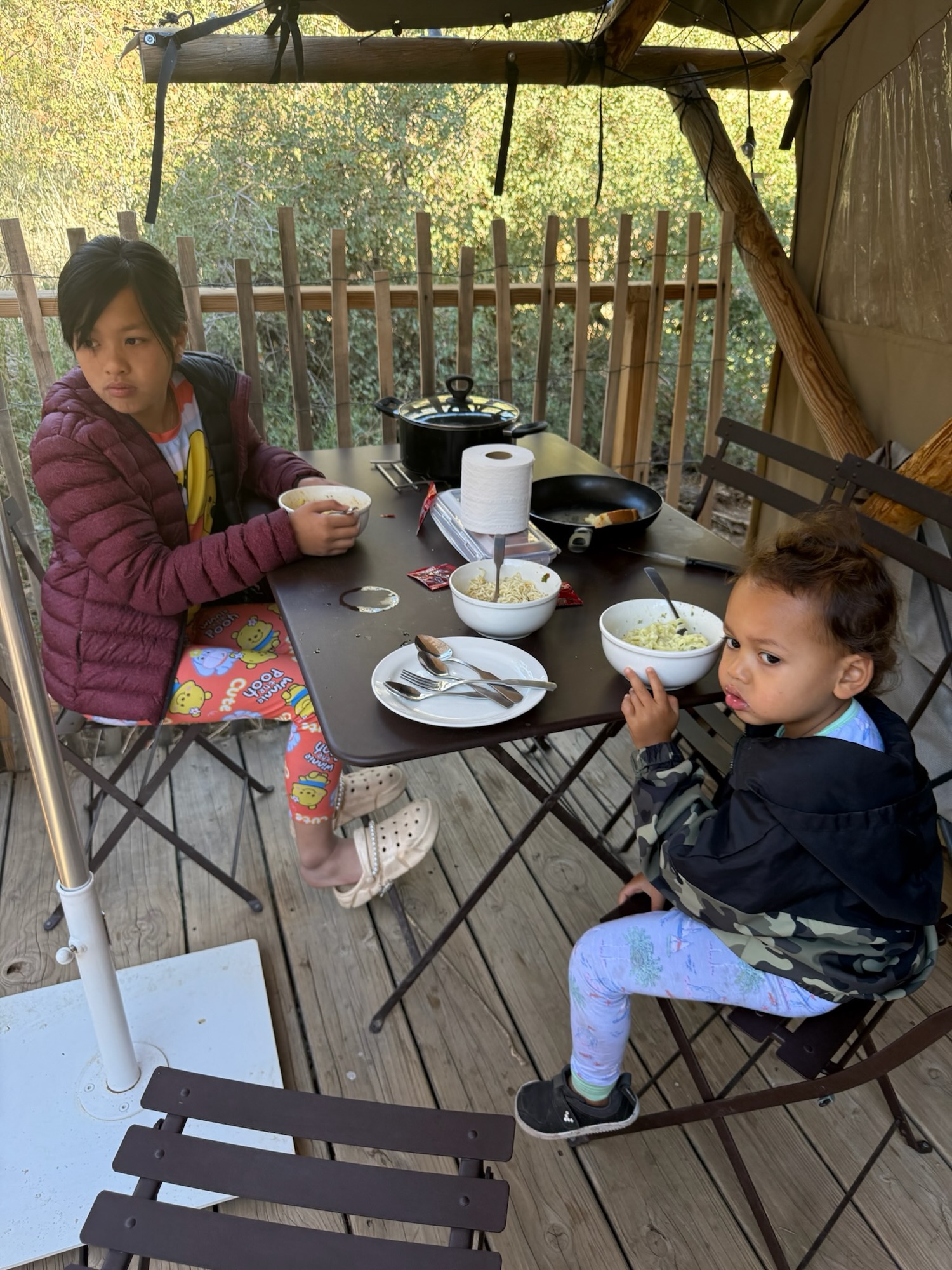 Paxton and Ai Vy hanging out at the tent deck