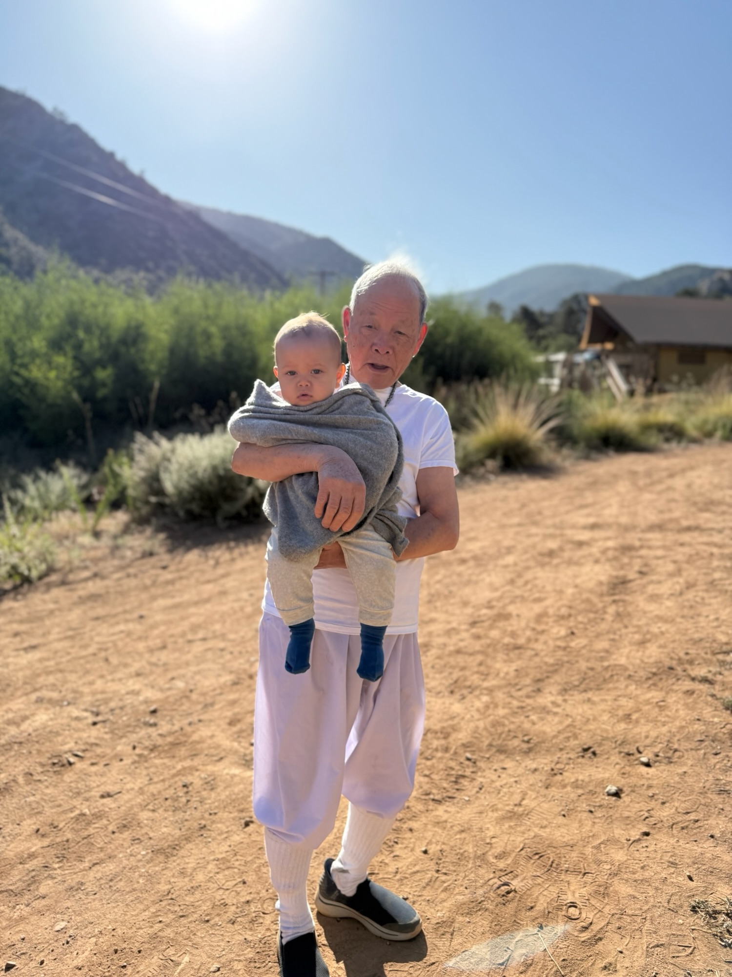 Grandpa holding baby Kai at camp