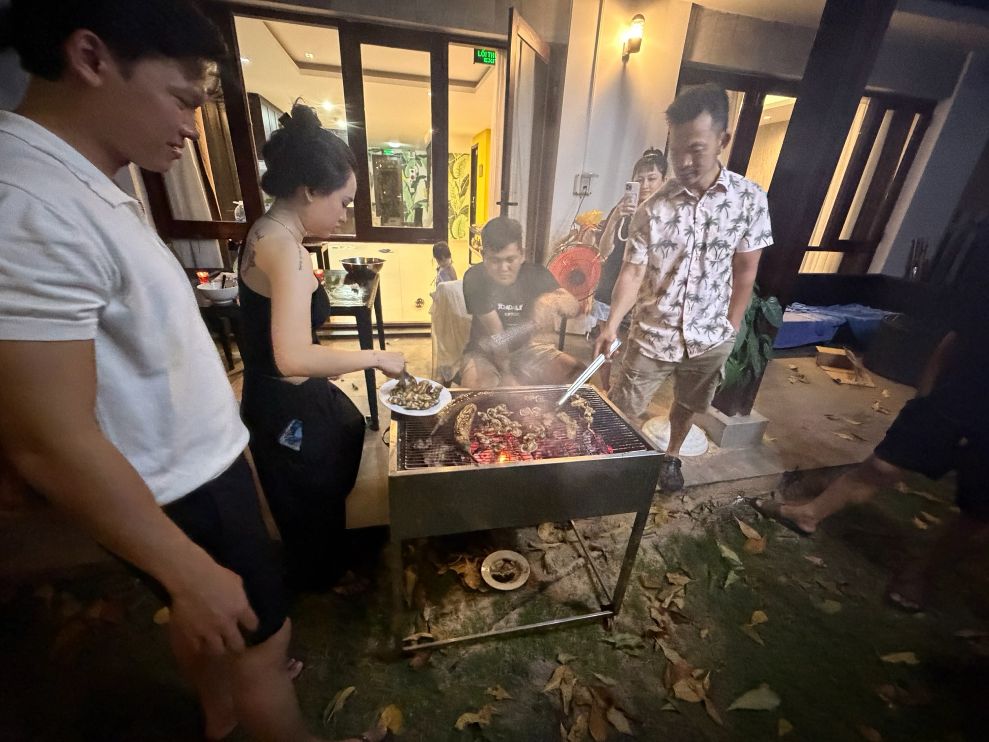 Large Vietnamese family grilling together at a hotel barbecue in Phu Quoc