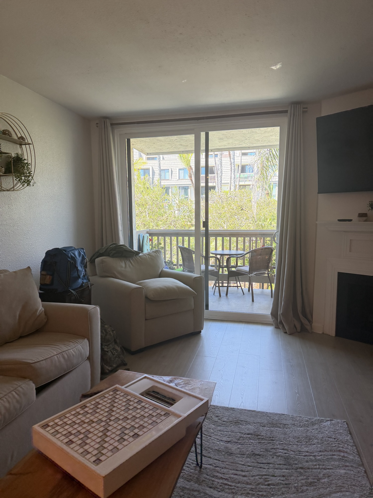 Cozy Oceanside condo living room with balcony and natural light