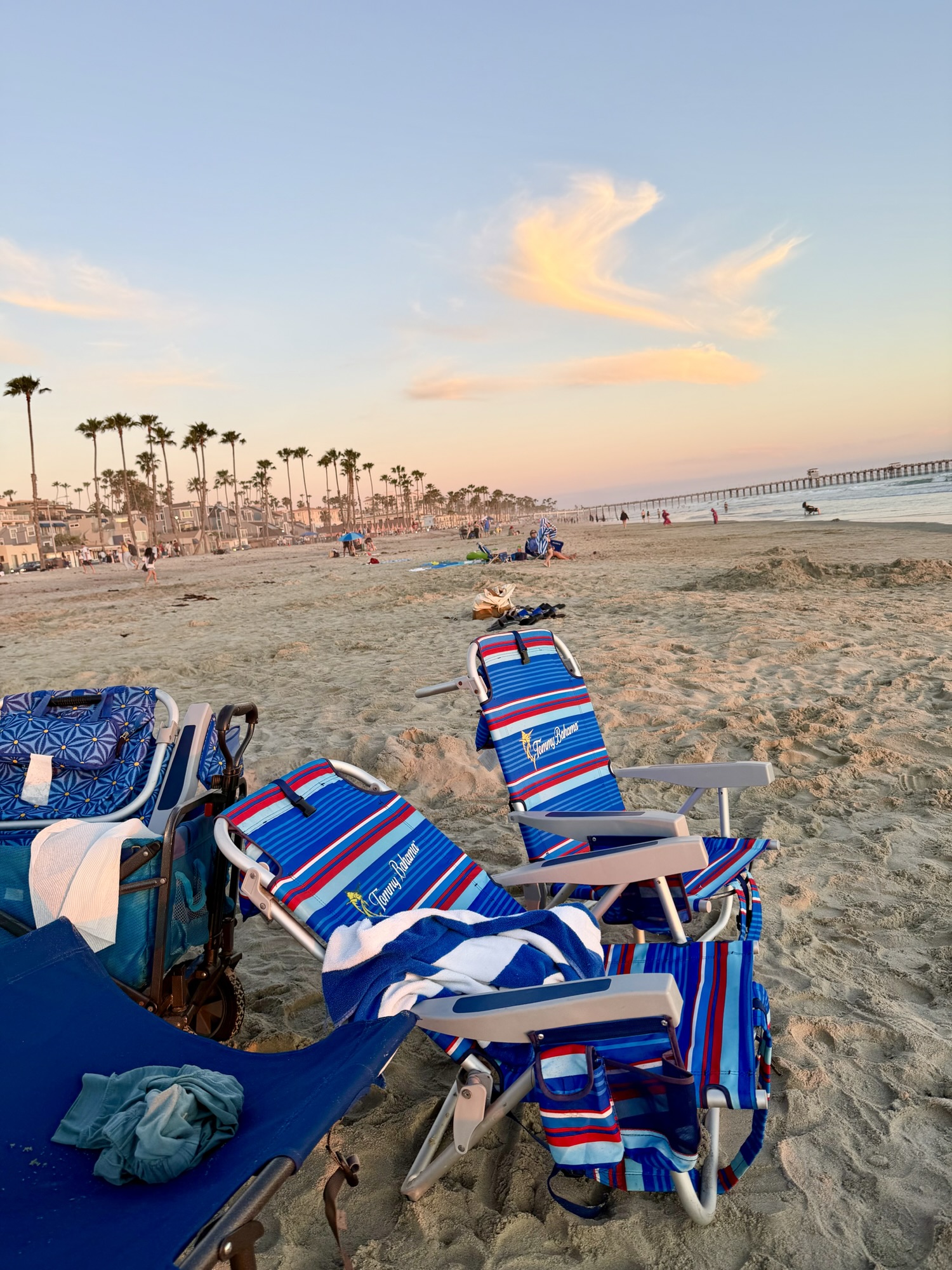 Striped beach chairs in the sand at sunset in Oceanside, California