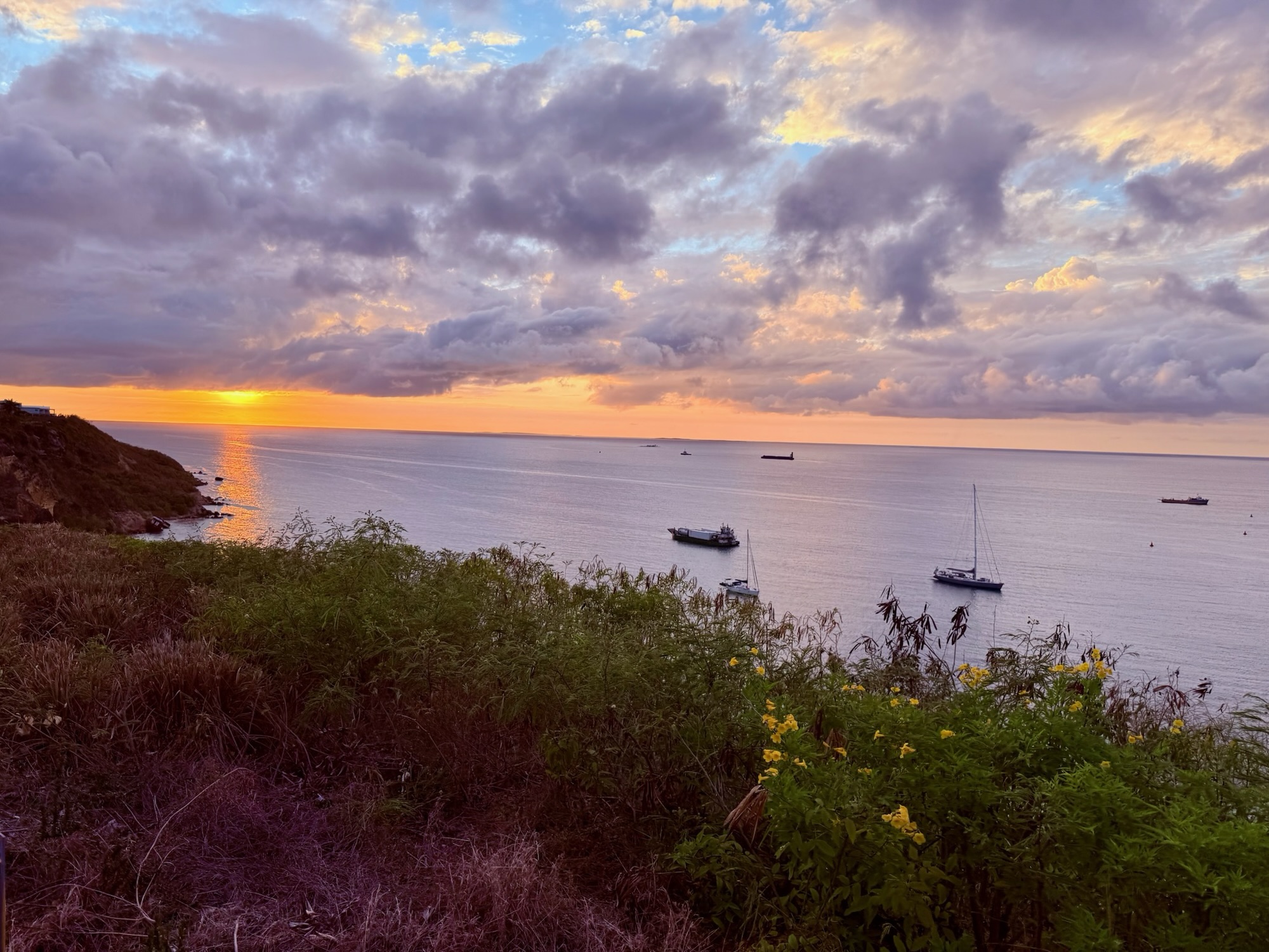 Sunset over sandy path and calm sea near Vincy’s restaurant in Anguilla