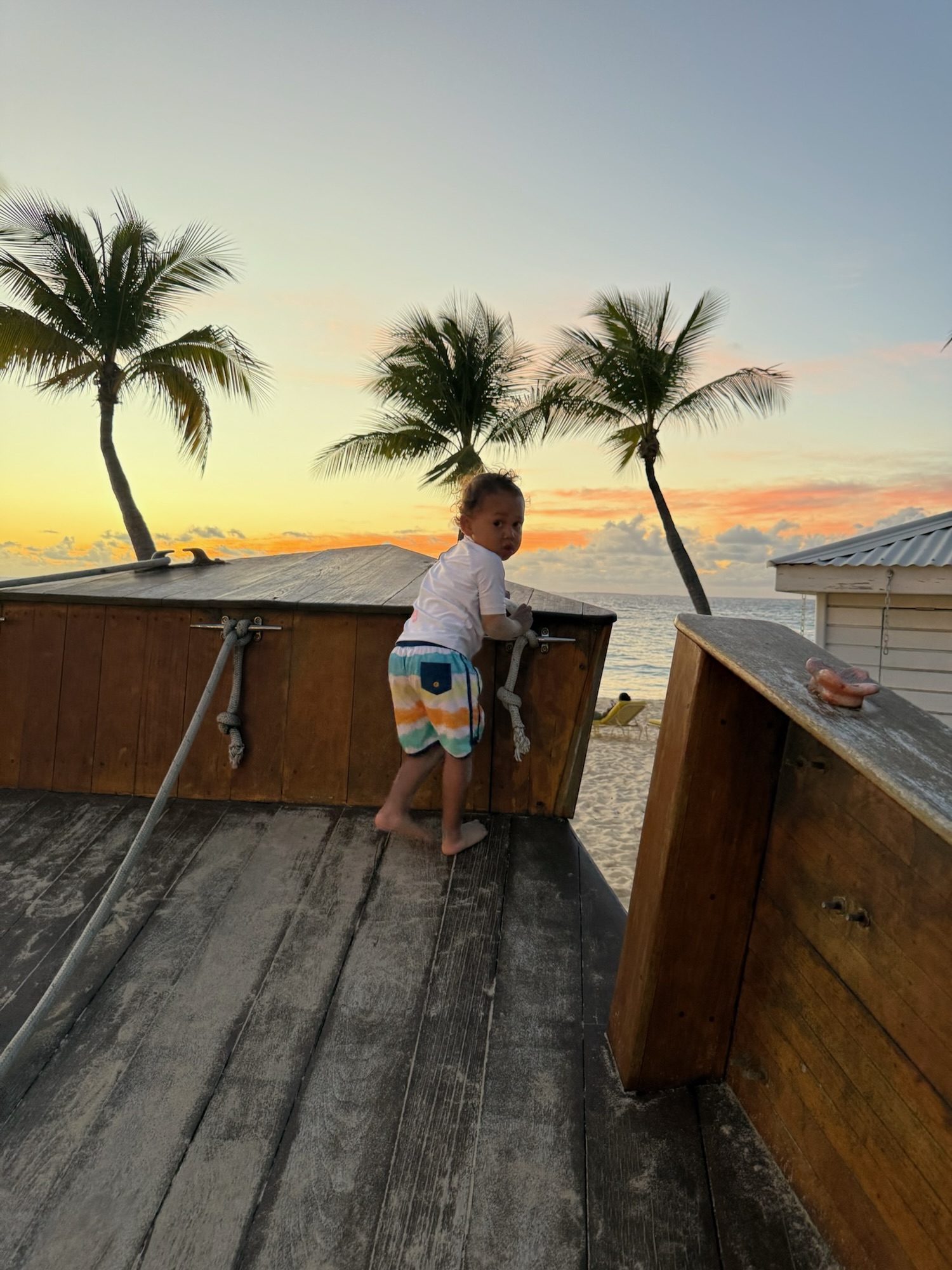 Kids playing in the sand at sunset in front of Leon’s restaurant on Meads Bay