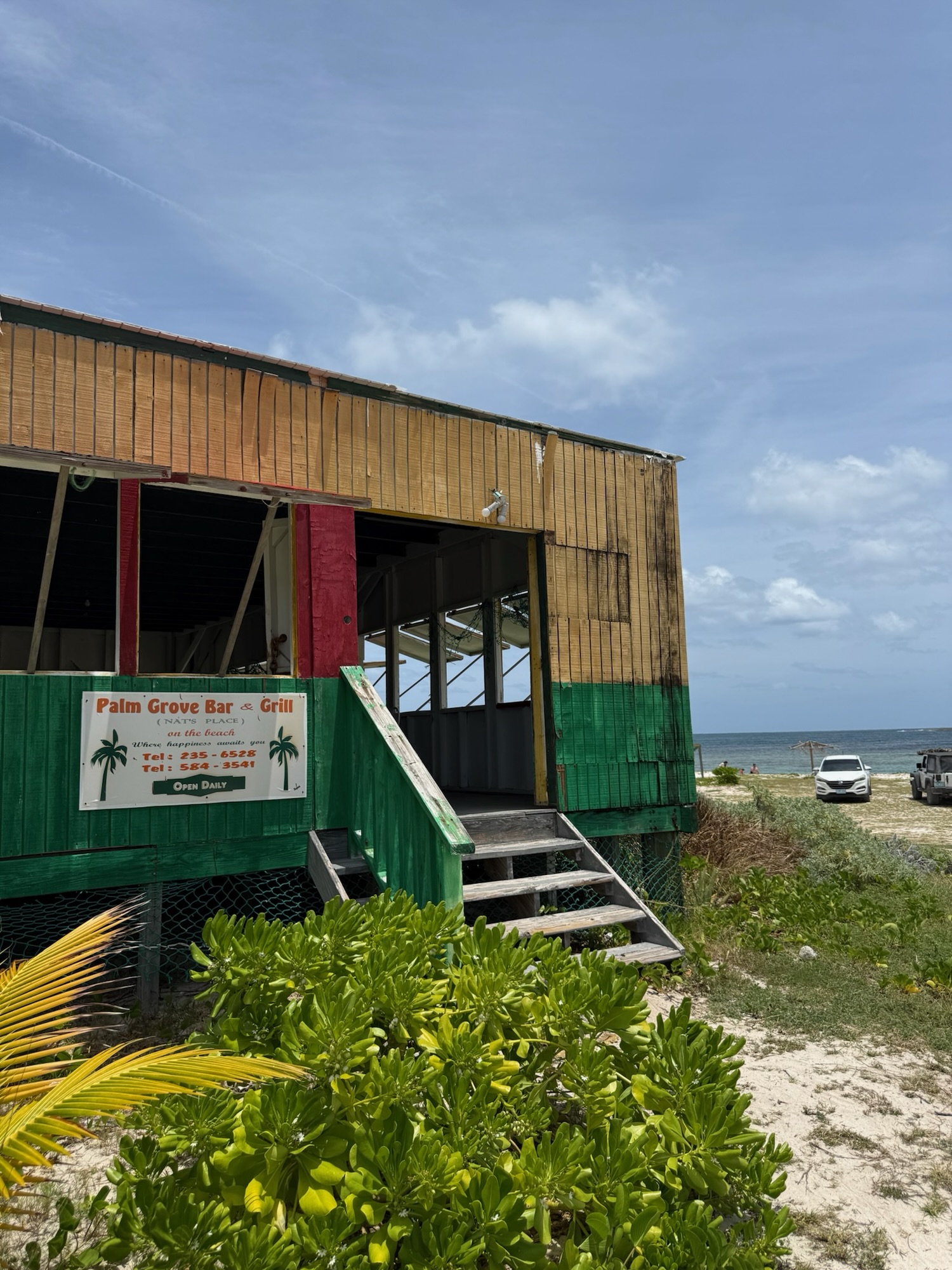 Colorful Palm Grove bar and grill at the end of an unpaved road in Anguilla
