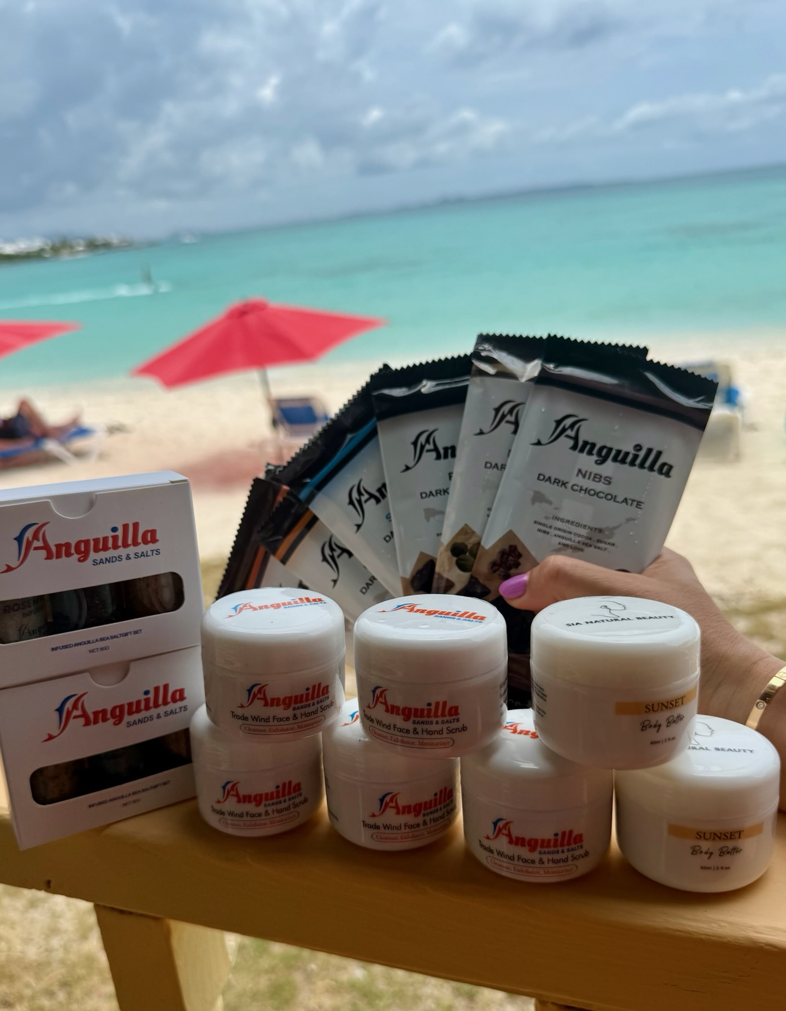 Selection of Anguilla Sands and Salts souvenirs on a wooden table