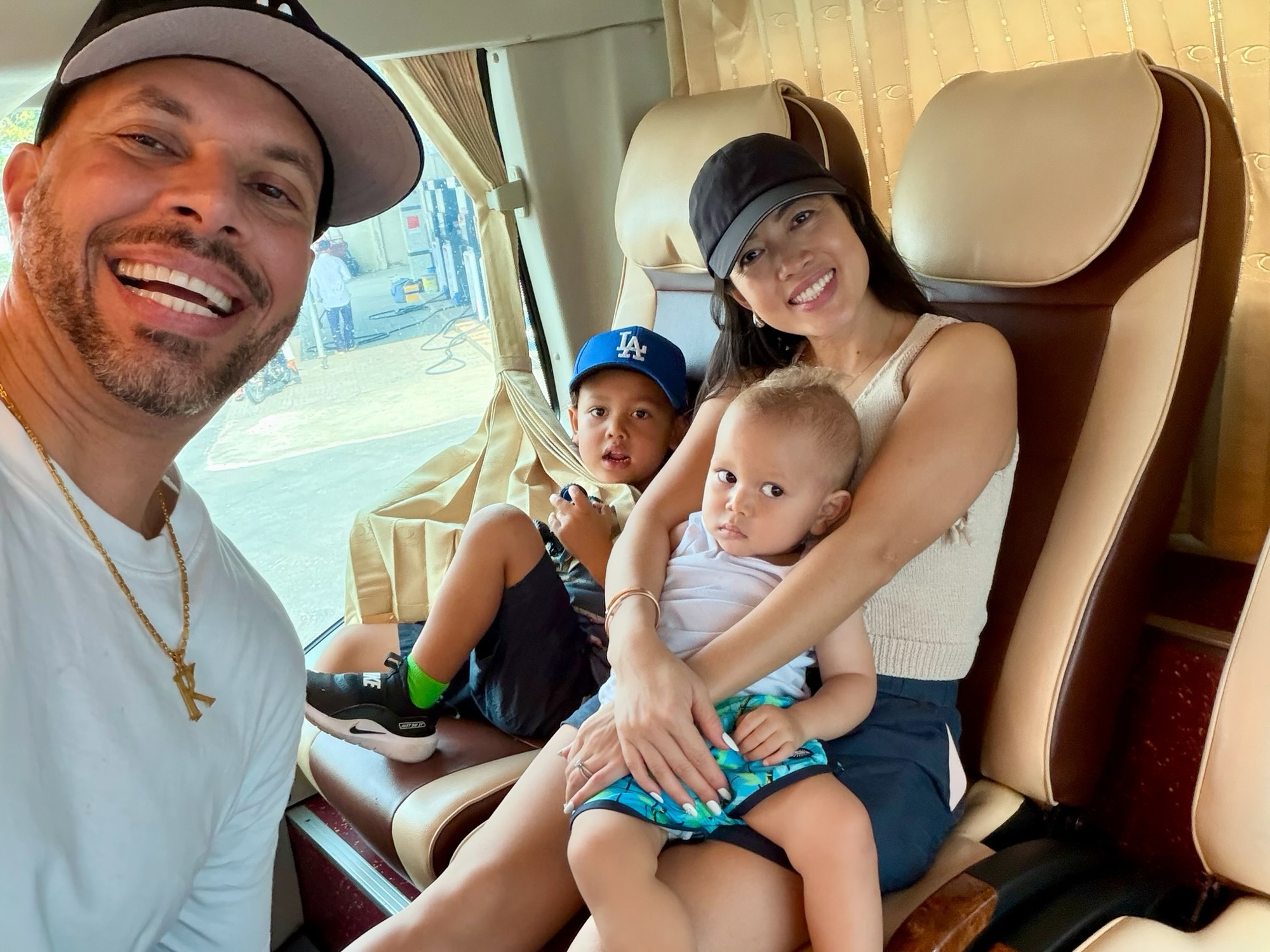 Family relaxing inside private car transfer in Vietnam with kids